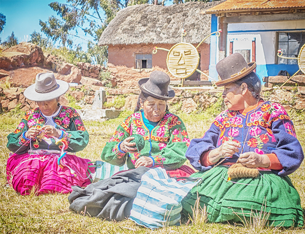 Aymara sisters spinning yarn