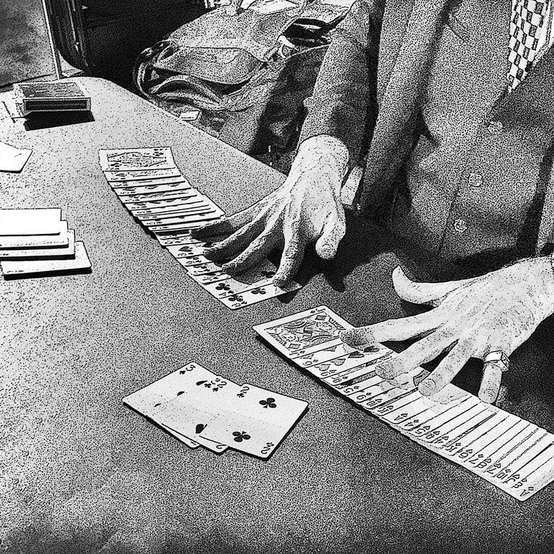 hands and cards of card trick. black and white.