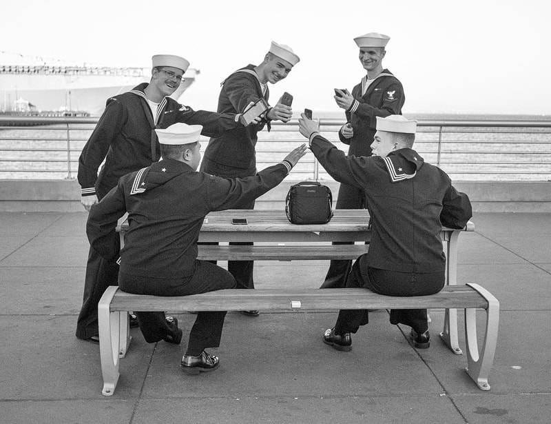 five sailors simulating toasting each other with smart phones.  black and white.