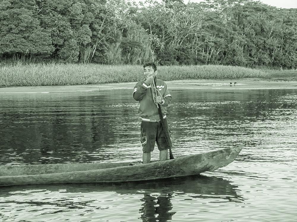 Young man on boat ready for day's fishing.  Amazon River.