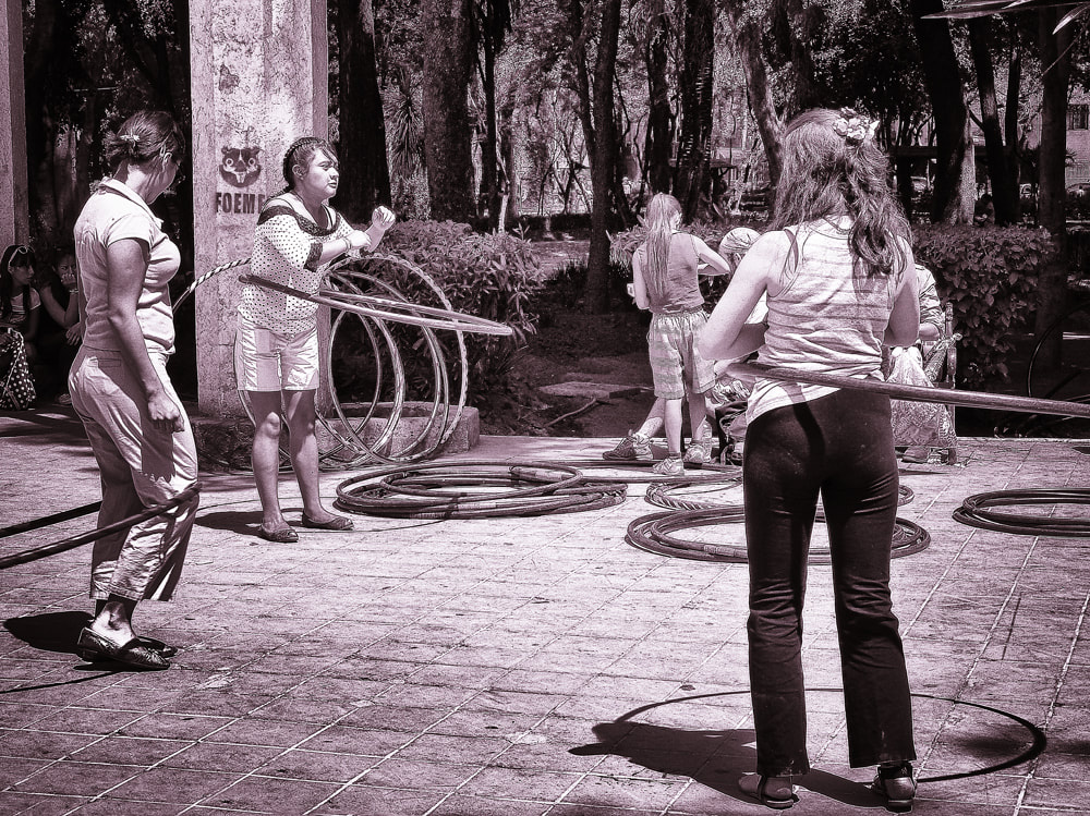 hula hoops, young girls playin in park. Mexico. 