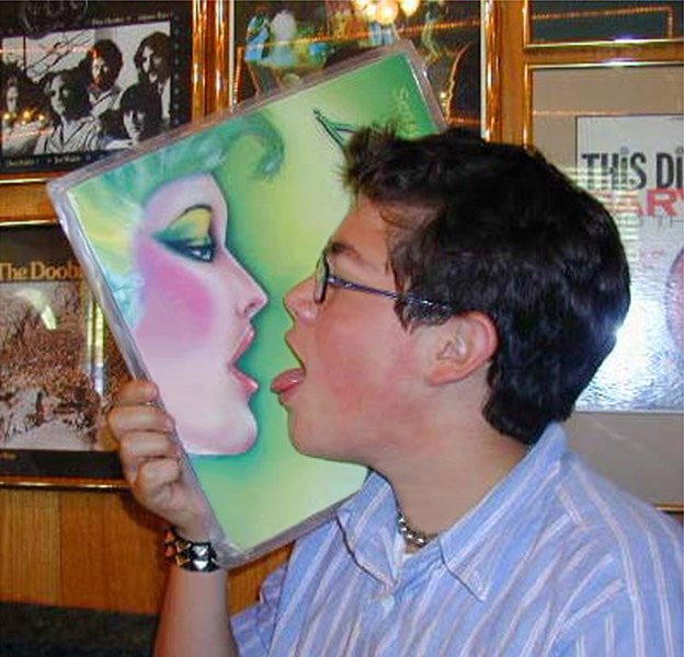 teenager mimicing picture on record album, face to face, reflection