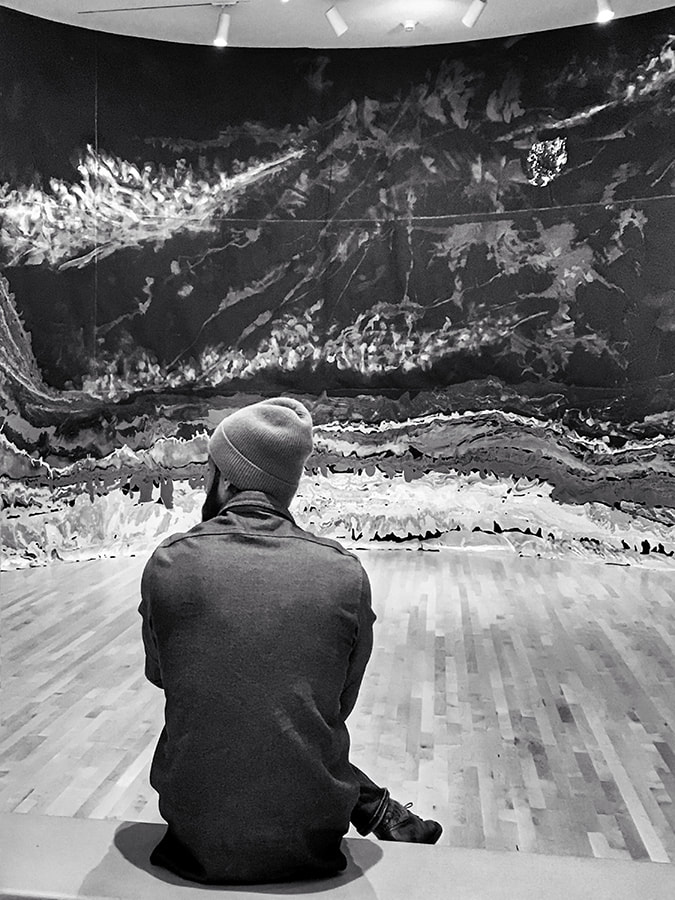 man alone in a gallery, mural, solitude, black and white