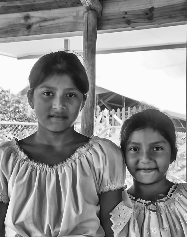 two young indigenous girls pose for camera.  black and white. costa rica