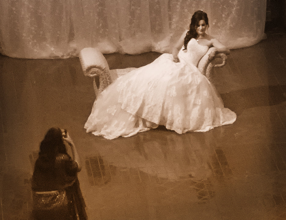 bride posing on a chaise for pre-wedding picture